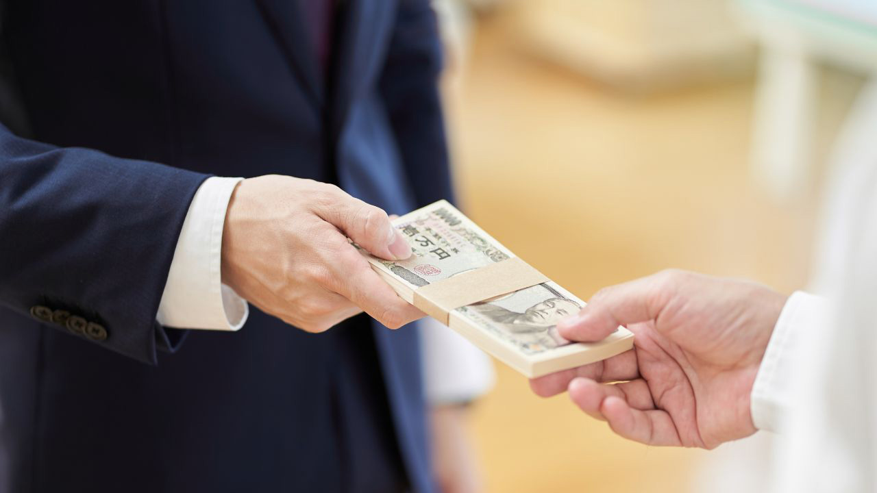 お金を受け渡している画像